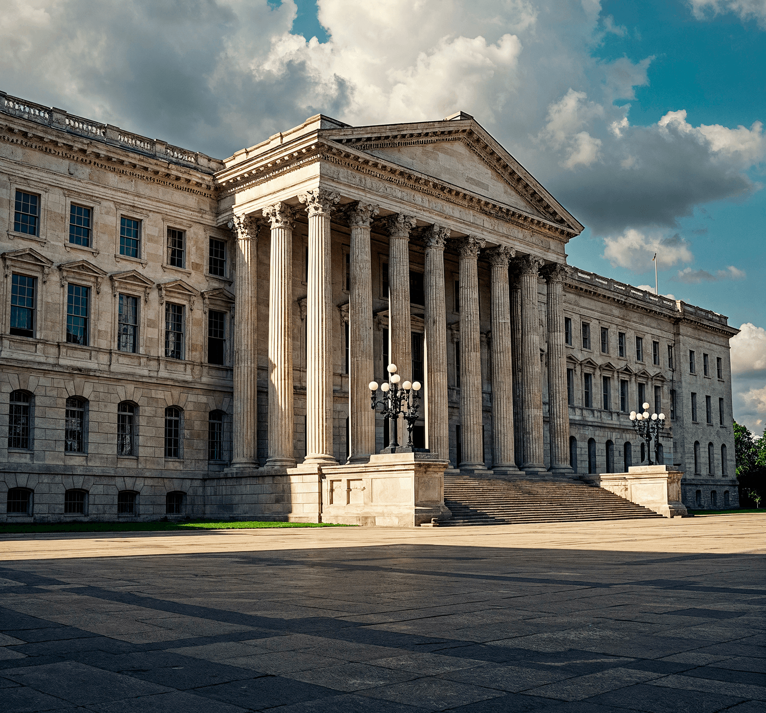 Large neoclassical building with tall columns, a grand staircase, and multiple windows, situated under a partly cloudy sky—an impressive structure evocative of tradition and authority, much like the diverse law firm practice areas it might house within its walls.